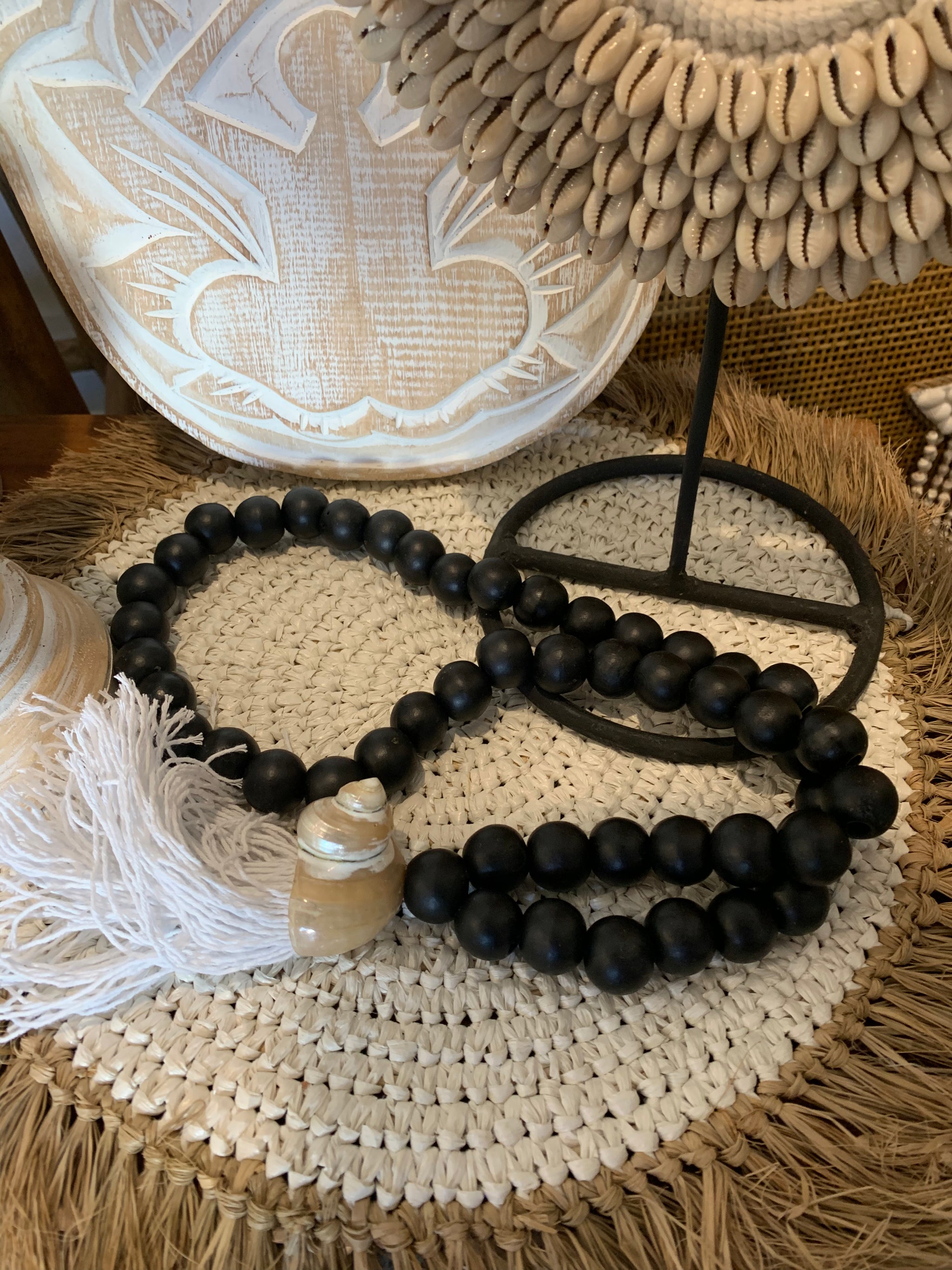 Black bead necklace / tassel decoration with shell detail and white tassel. - Bali Beach Beyond
