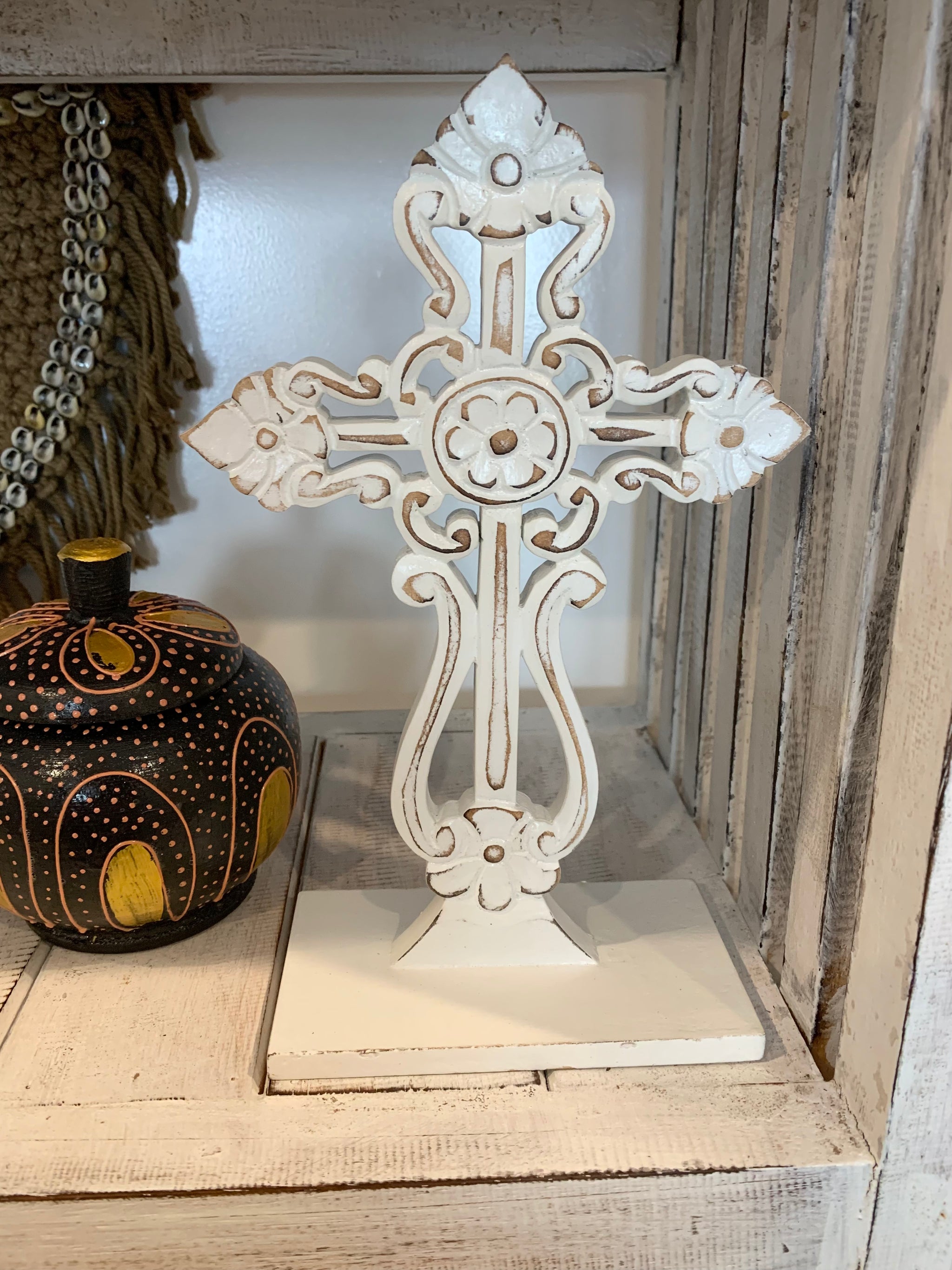 White carved cross on stand. - Bali Beach Beyond