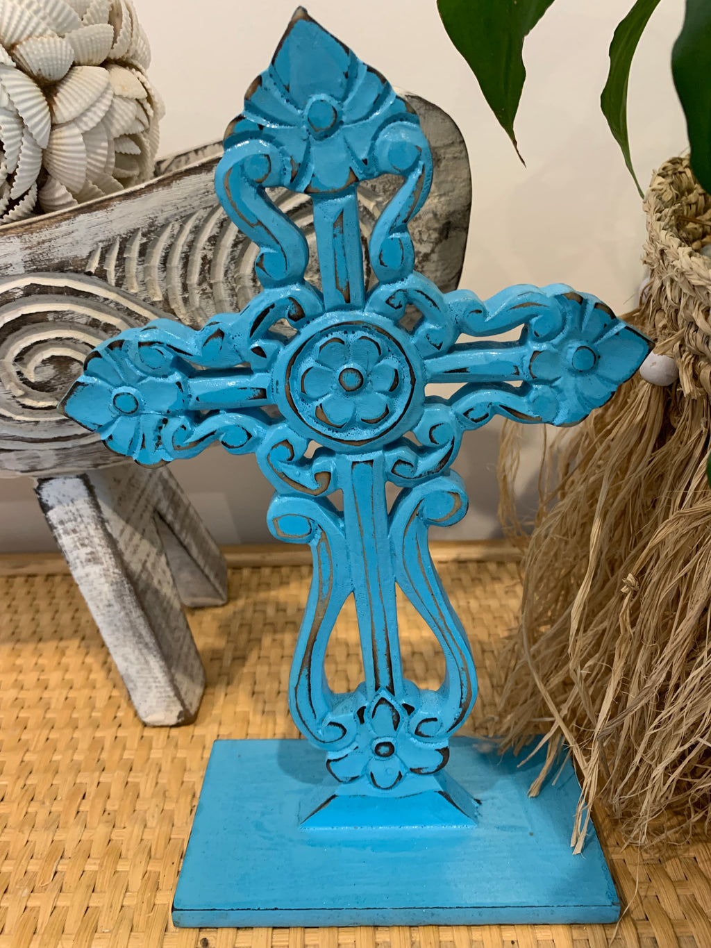 Blue carved cross on stand. - Bali Beach Beyond