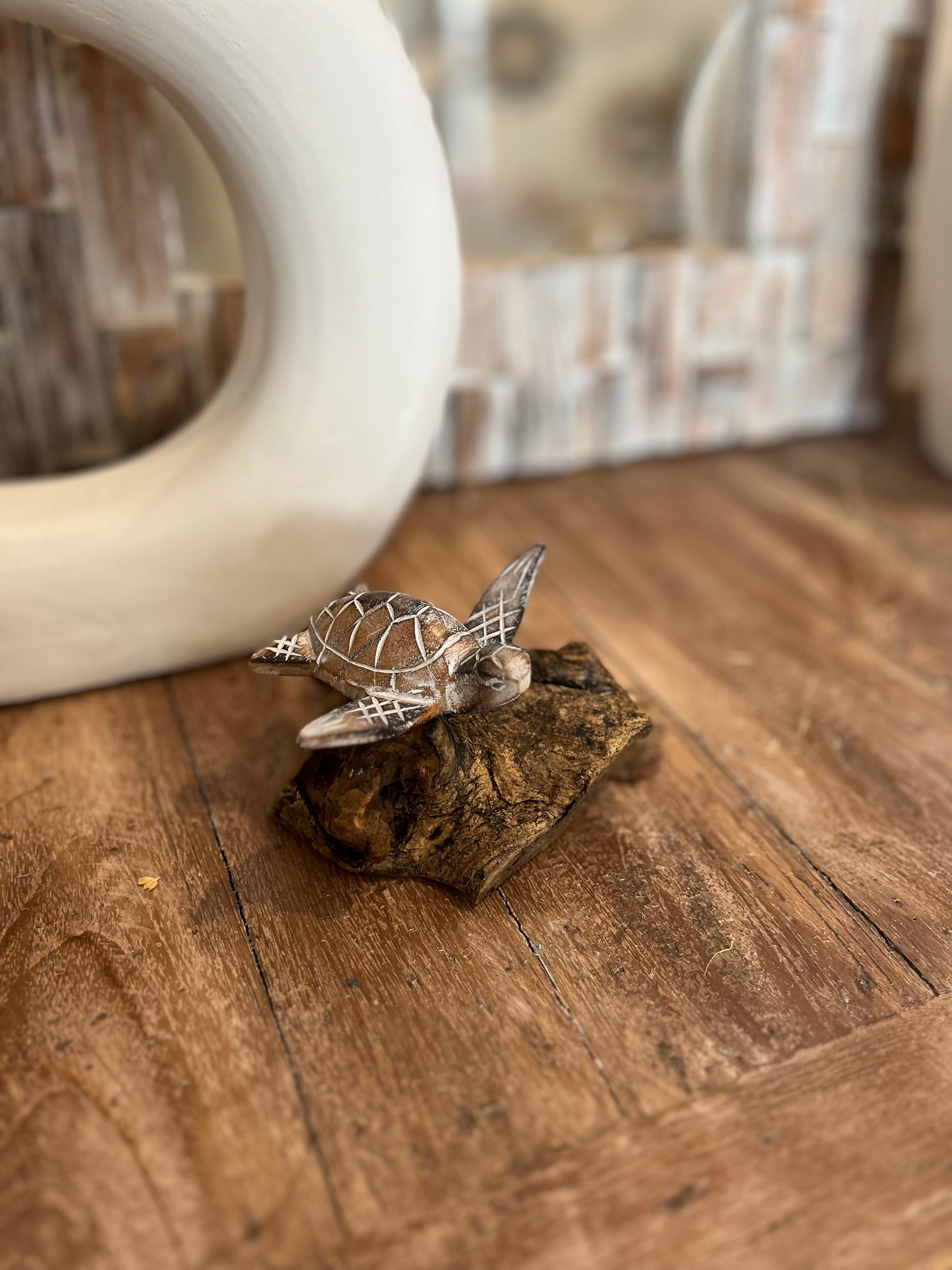 Brown handcarved timber turtle on wood