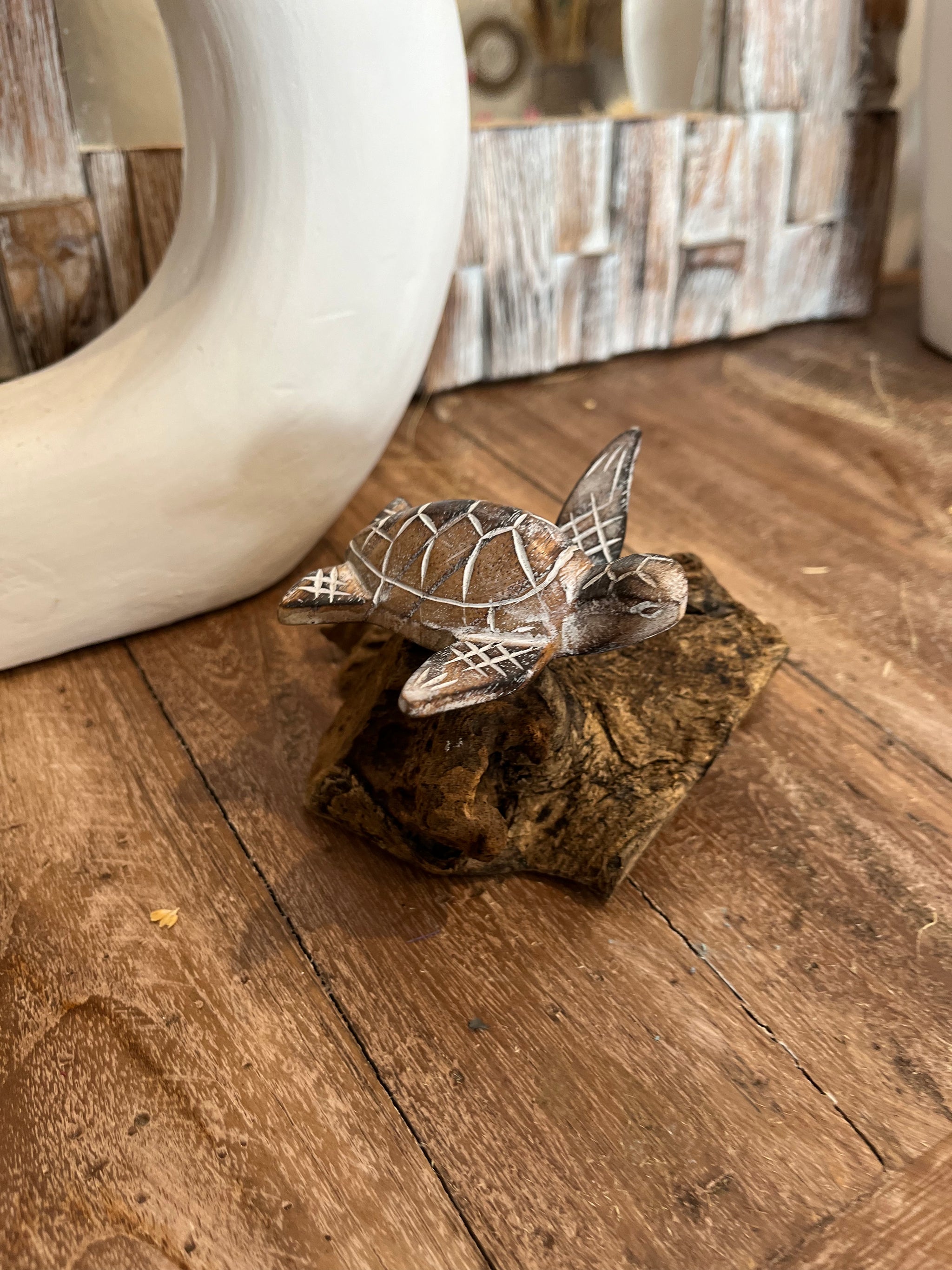 Brown handcarved timber turtle on wood