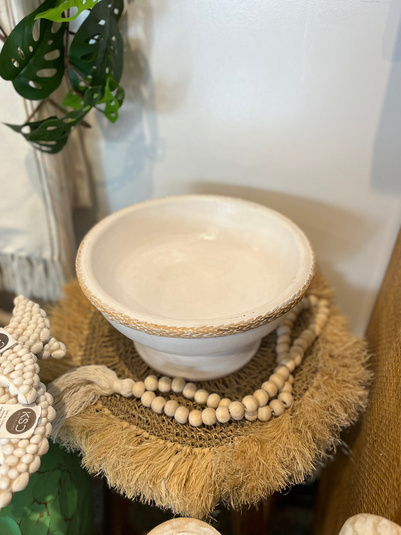 White timber pedestal platter with rattan edge detail.