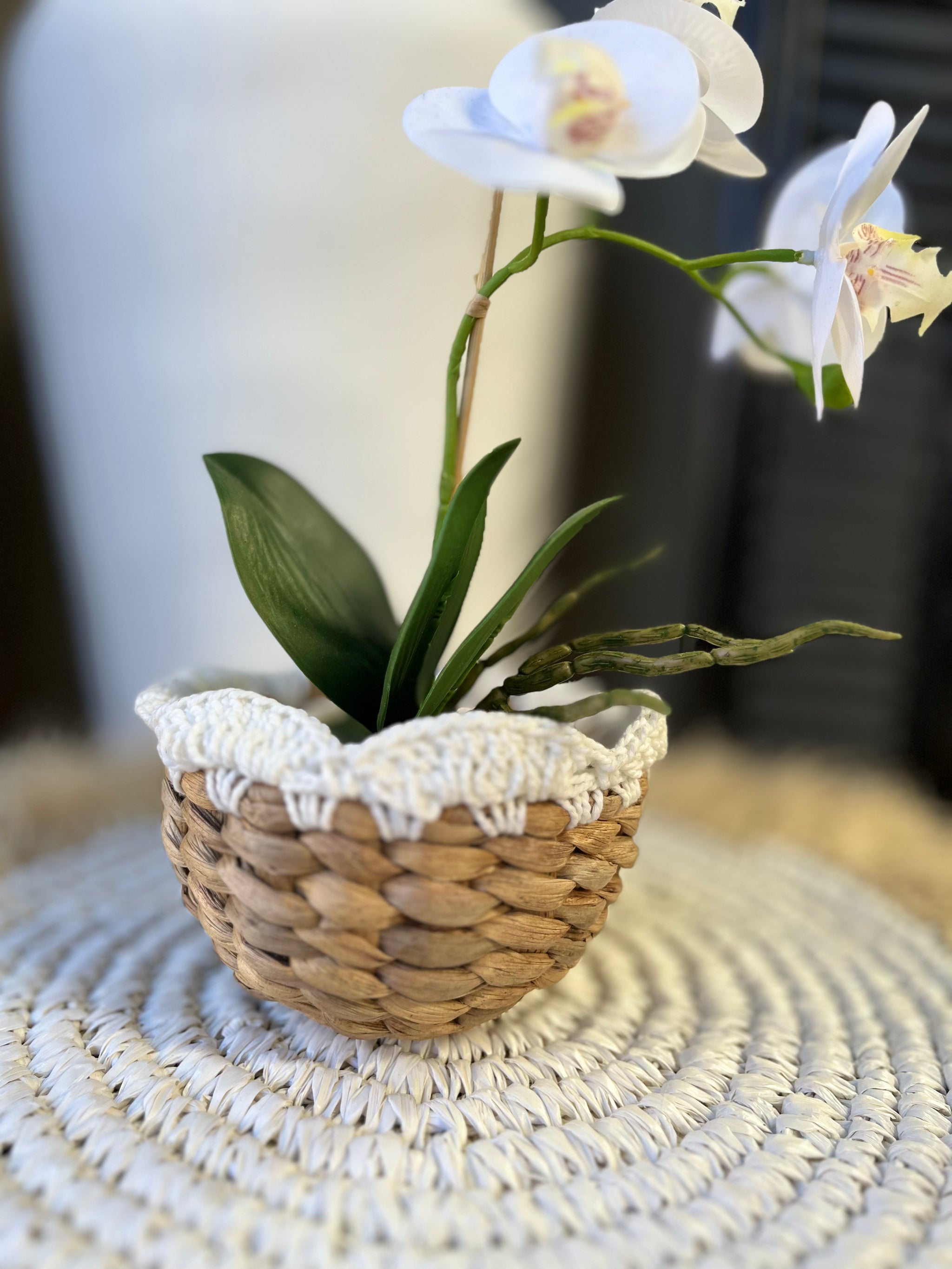 Woven basket with macrame detail at top