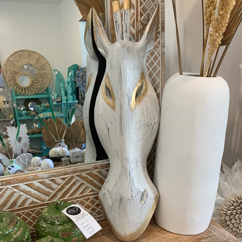 White timber giraffe mask. Wall hanging