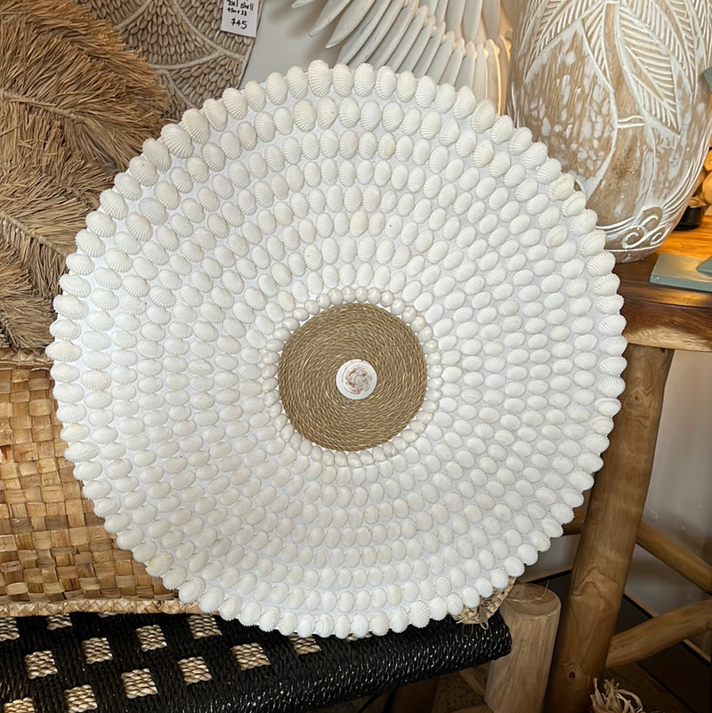 Round detailed shell wall hanging.