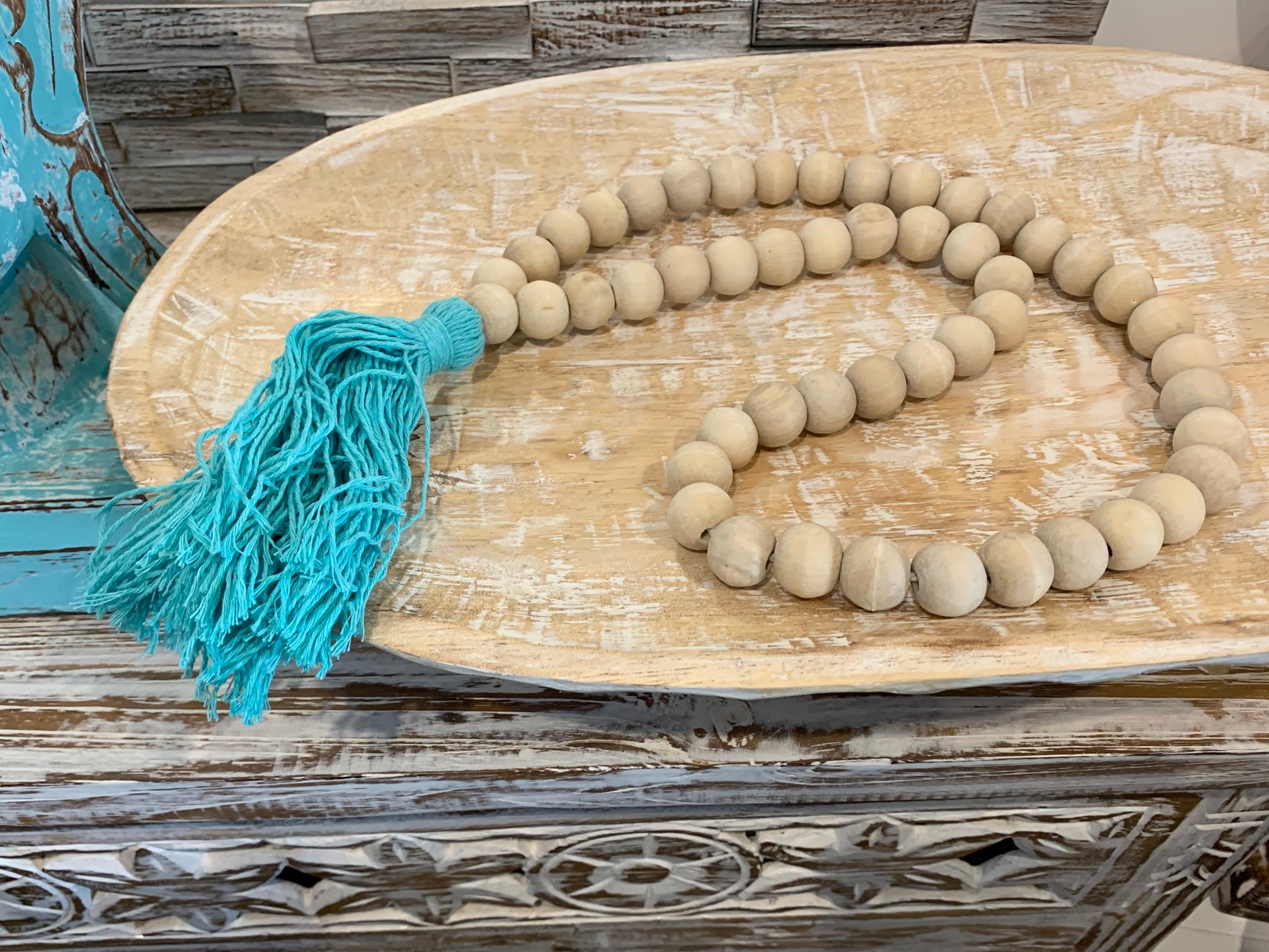 Natural bead and blue tassel hanging.